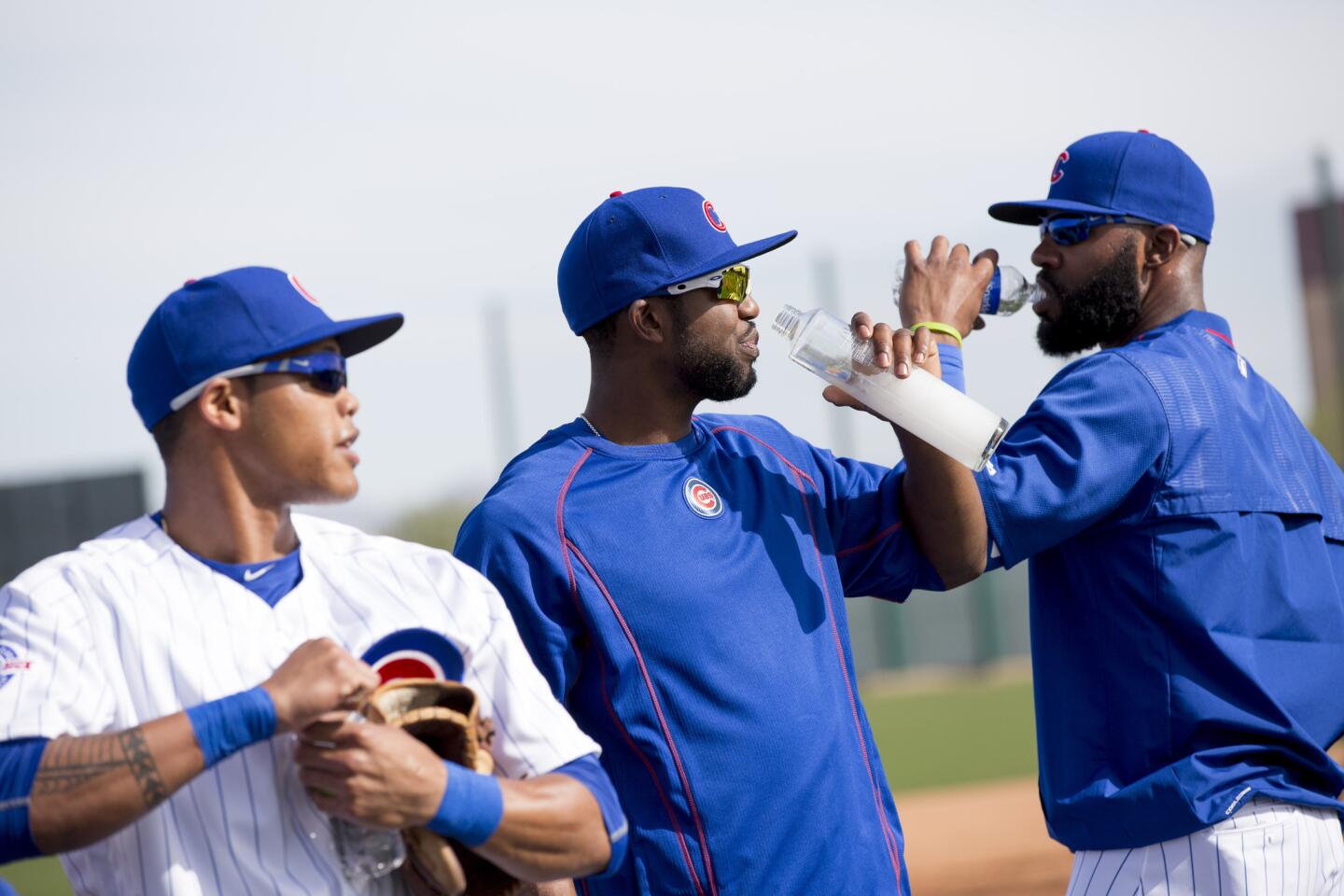 From left, Addison Russell, Dexter Fowler, and Jason Heyward take a drink while attending practice during spring training at Sloan Park on Monday, Feb. 29, 2016, in Mesa, Ariz.