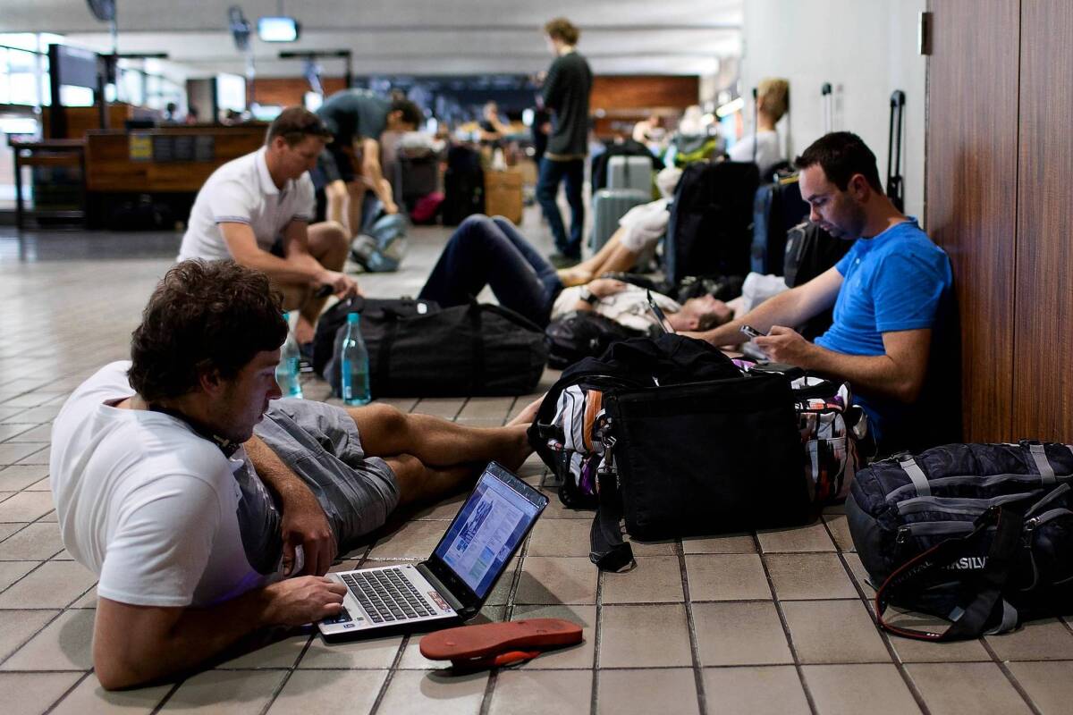 The Global Business Travel Assn. is expecting companies to spend $266.7 billion in 2013. That would be a 4.6% increase over last year, when the “fiscal cliff” and Superstorm Sandy put a crimp in travel. Above, travelers at Honolulu International Airport in Hawaii in February 2012.