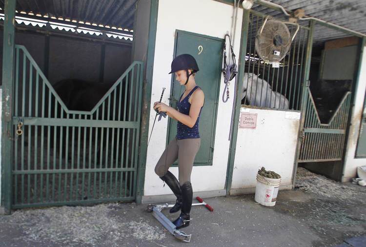 Rison Harrison gets ready to ride on one of her favorite horses, Kantor, at Paddock Riding Club in Los Angeles on Thursday, August 17, 2011. Harrison has been riding since she was five-years-old. She will be competing in the Dressage Equitation Finals next week in Chicago.