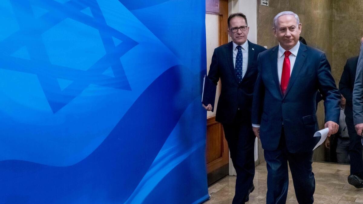 Israeli Prime Minister Benjamin Netanyahu, right, arrives for the weekly Cabinet meeting at the prime minister's office in Jerusalem, on Sunday.