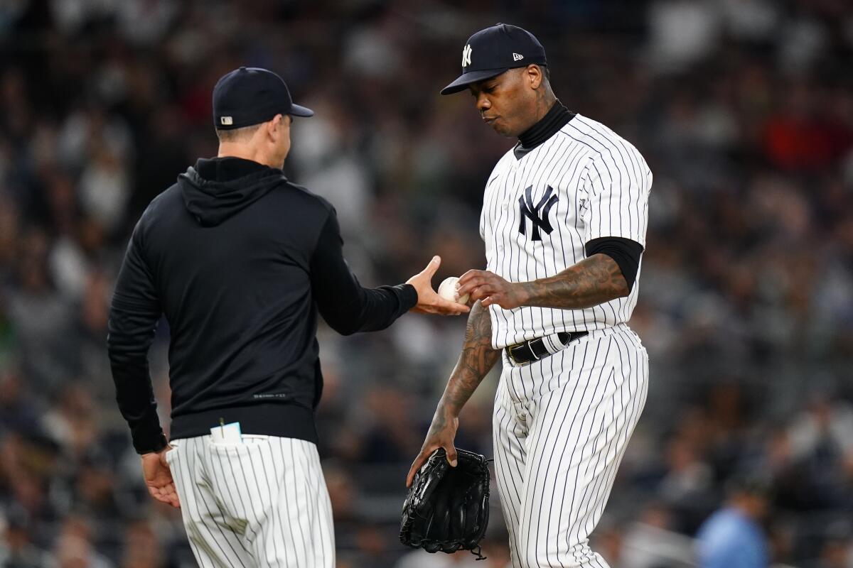 New York Yankees relief pitcher Aroldis Chapman hands the ball to manager Aaron Boone during the eighth inning of a baseball game against the Boston Red Sox Thursday, Sept. 22, 2022, in New York. (AP Photo/Frank Franklin II)