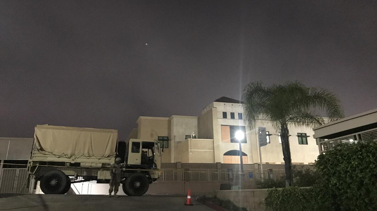 A California National Guard member stands outside the La Mesa Police Department on Wednesday night