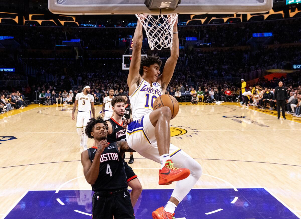 Lakers guard Max Christie dunks in front of  Houston Rockets guard Jalen Green.