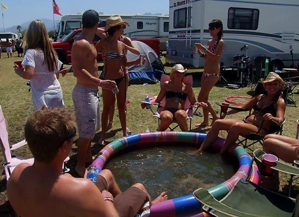 A group of friends from Orange County lounge beside the baby pool they brought with them in their RV.