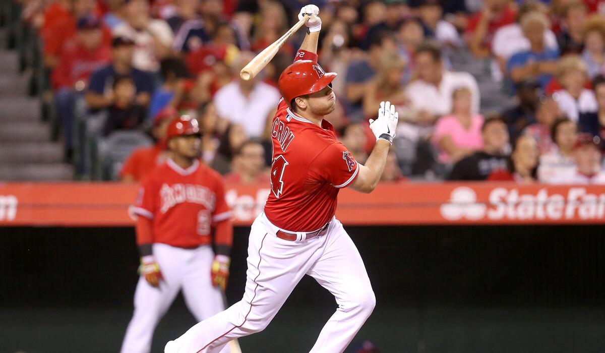 Angels' C.J. Cron hits an RBI triple in the fifth inning against the Texas Rangers on Friday.