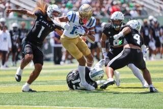 HONOLULU, HI - AUGUST 31: Carter Shaw #14 of the UCLA Bruins is slowed down.