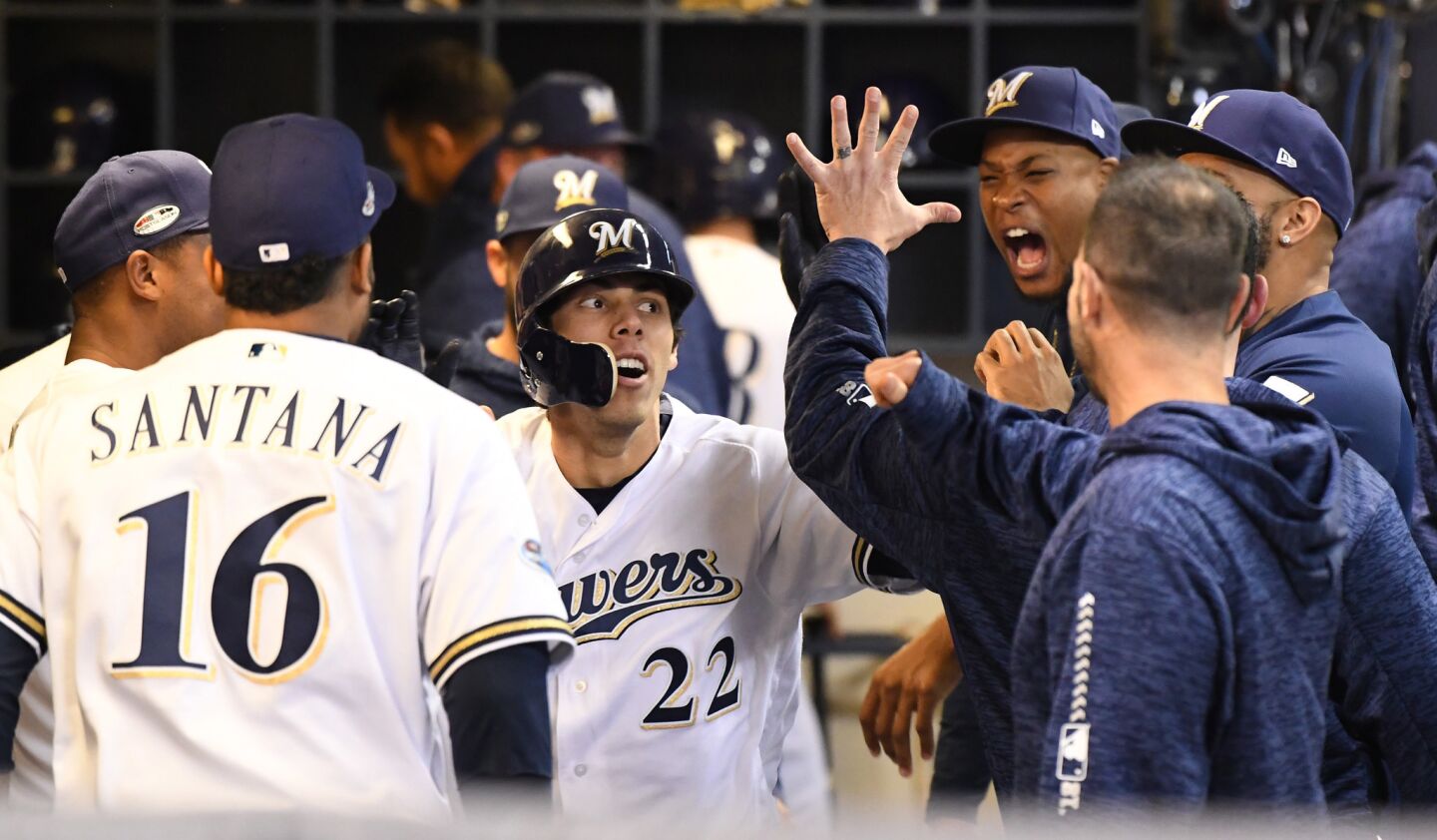 Milwaukee Brewers Christian Yelich celebrates in the dugout after hitting a solo homerun in the first inning.