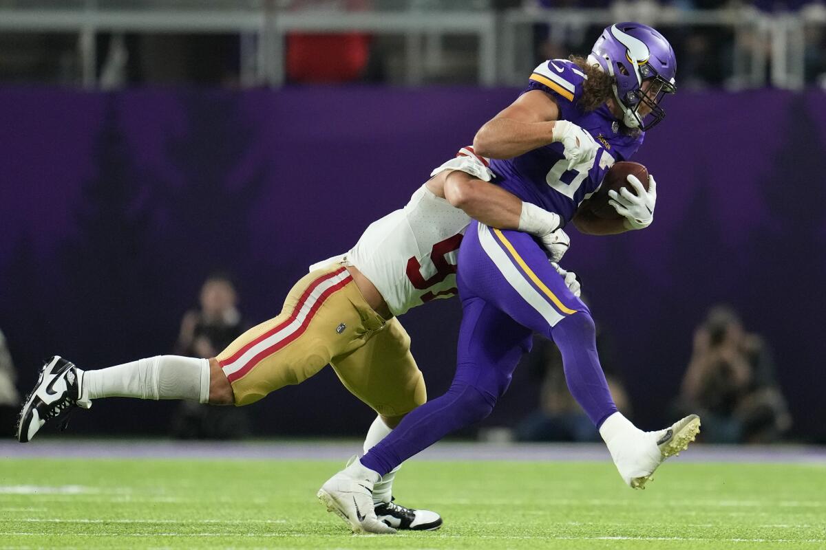 Minnesota Vikings tight end T.J. Hockenson is tackled by San Francisco 49ers defensive end Nick Bosa.