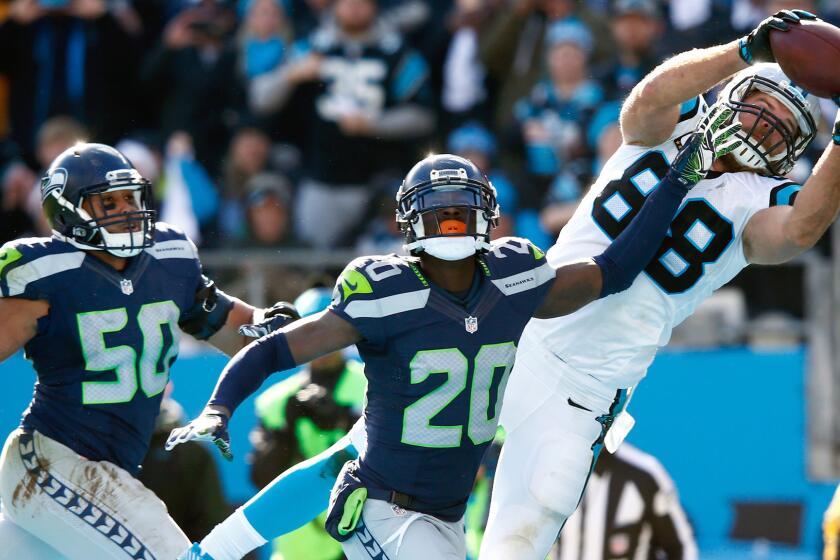 Panthers tight end Greg Olsen makes a 19-yard touchdown catch against Seahawks cornerback Jeremy Lane (20) and linebacker K.J. Wright (50) for a 31-0 lead in the second quarter Sunday.