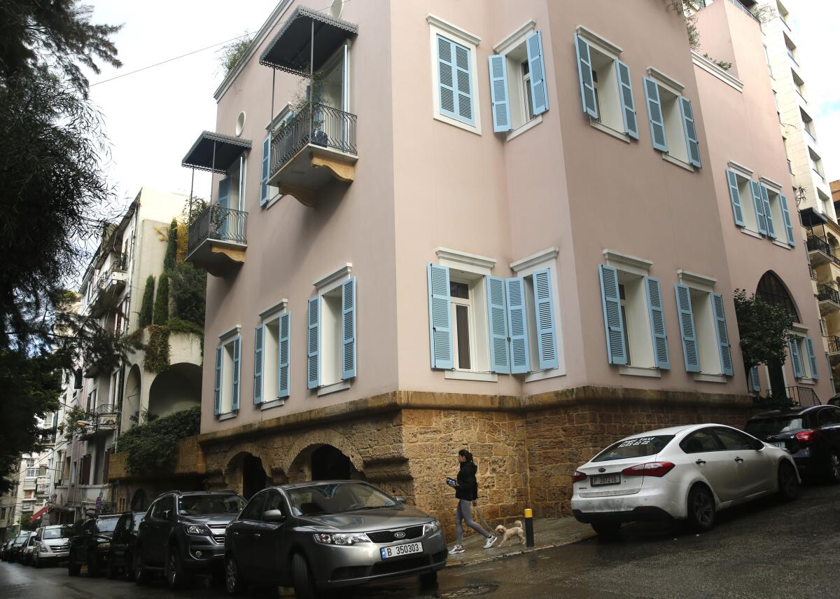 A woman walks past the home of former Nissan chief Carlos Ghosn in Beirut on Sunday.
