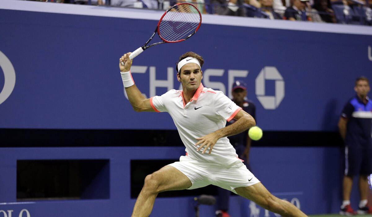 Roger Federer returns a shot to Stan Wawrinka during a semifinal match at the U.S. Open tennis tournament on Friday.
