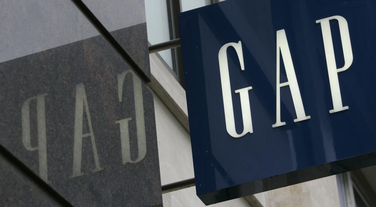 FILE - In this Wednesday, Aug. 13, 2018 file photo, a sign for the Gap store seen in London's Oxford Street. American clothing retailer Gap announced that it will close all of its 81 stores in the U.K. and Ireland by the end of 2021. It will shift its business to exclusively online. The announcement late Wednesday, June 30, 2021, comes following a strategic review that sought more cost-effective solutions for its presence in Europe. (AP Photo/Alastair Grant, File)