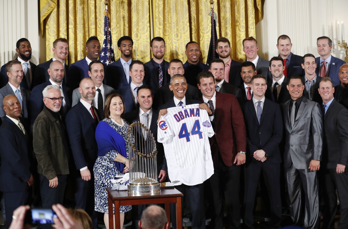 President Barack Obama holds up a personalized Chicago Cubs baseball jersey presented to him for a group photo during a ceremony in the East Room of the White House in Washington, Monday, Jan. 16, 2017, where the president honored the 2016 World Series Champion baseball team. (AP Photo/Pablo Martinez Monsivais)