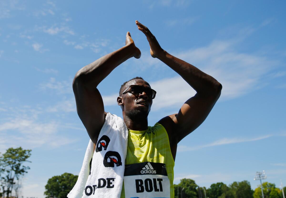 Usain Bolt of Jamaica acknowledges the fans at Icahn Stadium in Randall's Island, N.Y. on Saturday after winning the 200-meter at the Adidas Grand Prix.