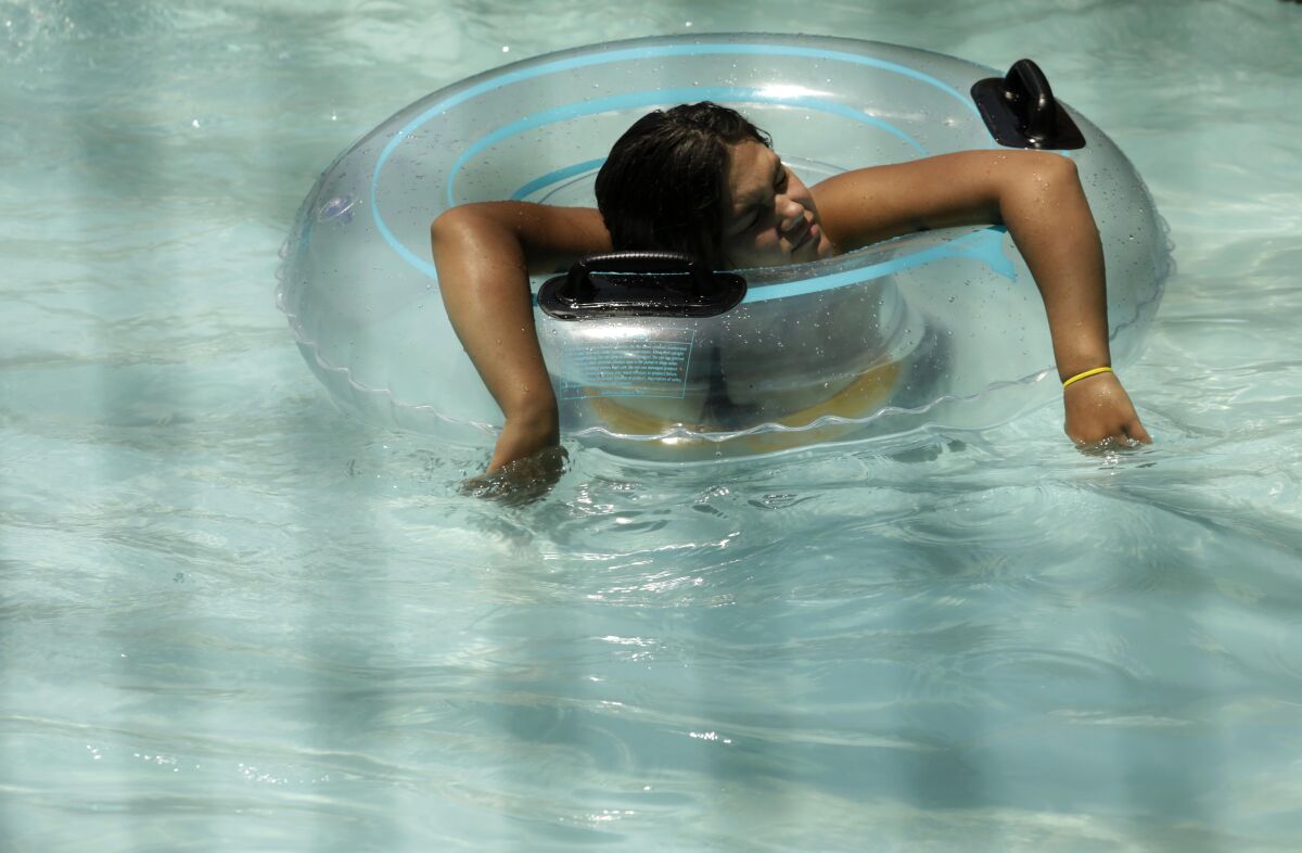 A woman cools off at DryTown Water Park in Palmdale, where the temperature reached 107 degrees by 3 p.m. Sunday.
