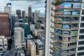 A view of downtown L.A. shows a high-rise covered in colorful graffiti bearing names like KRAZY and FOREVER