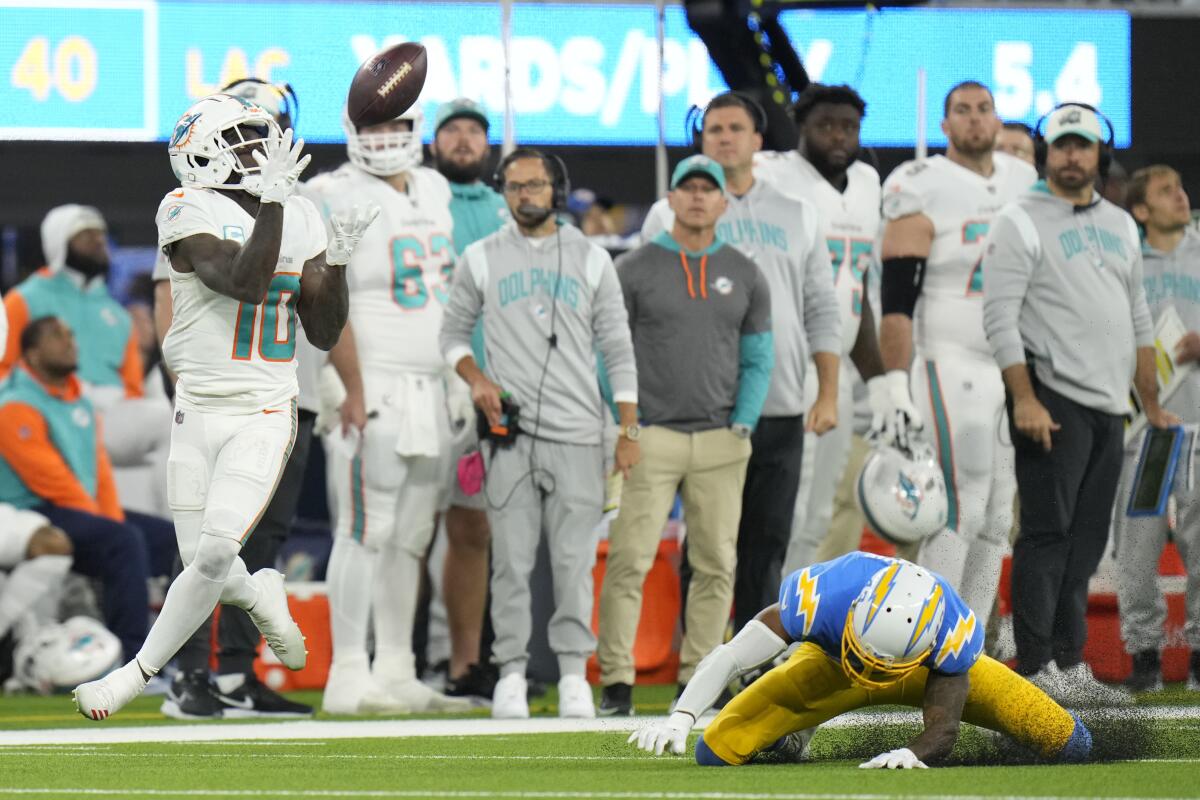 Miami Dolphins wide receiver Tyreek Hill catches a touchdown over Chargers cornerback Michael Davis.