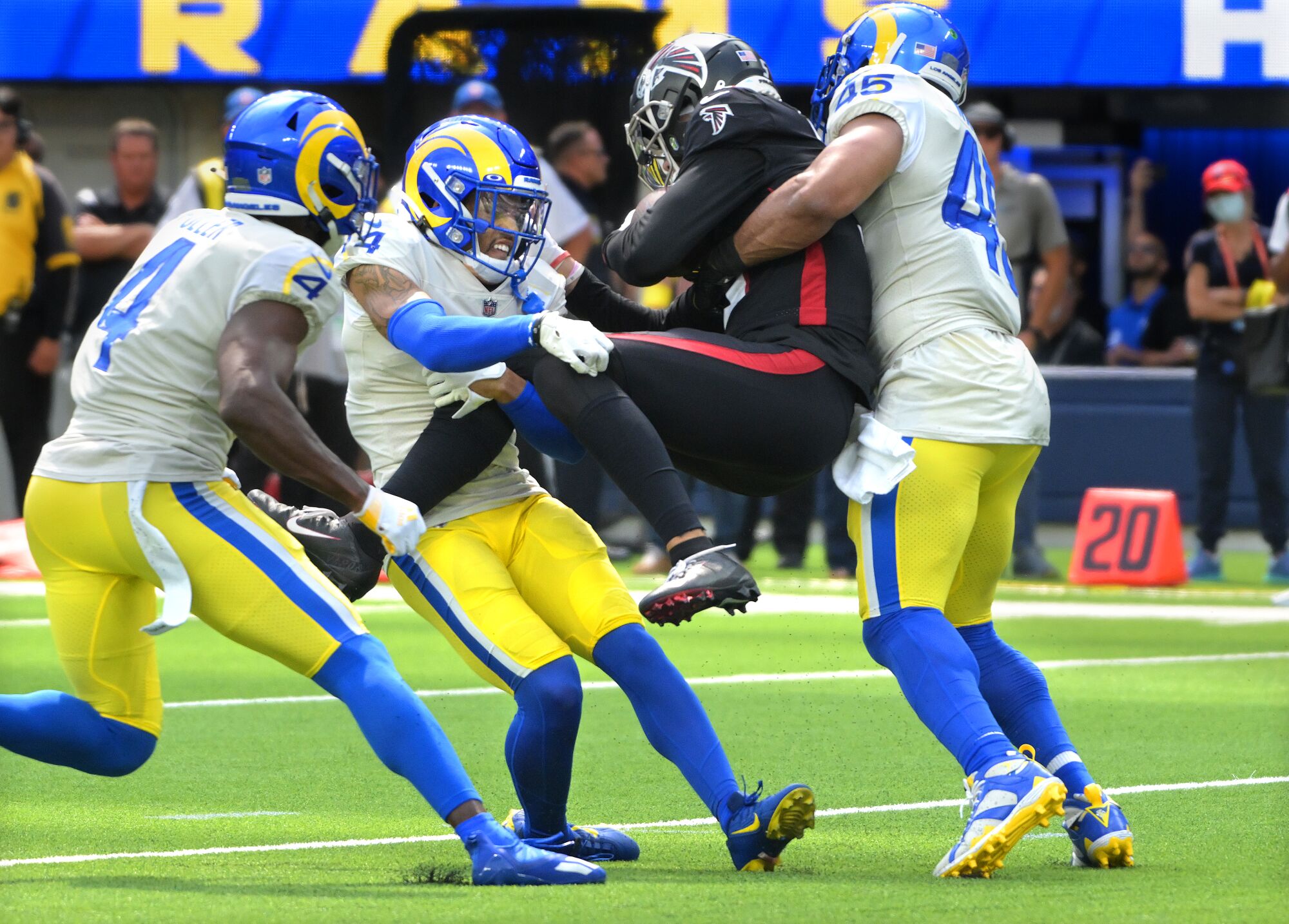 Rams defenders Jordan Fuller, Cobie Durant and Bobby Wagner take down Falcons receiver Drake London.