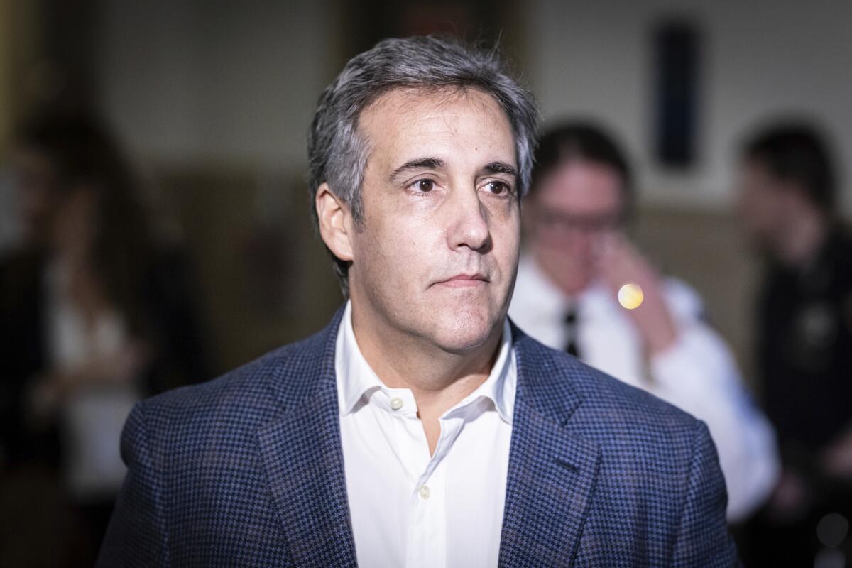 Michael Cohen in a white collared shirt and blue checked suit jacket.