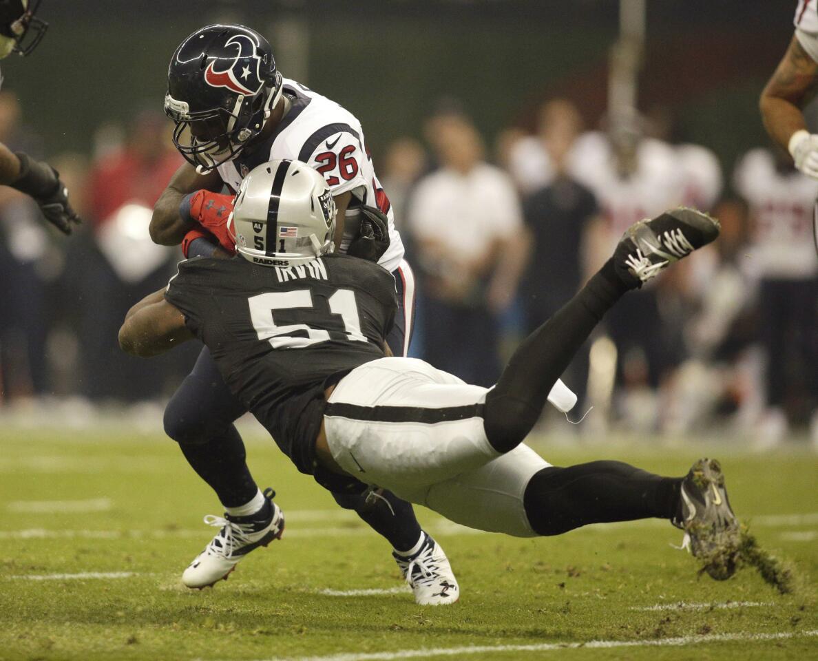 Nov 21, 2016; Mexico City, MEX; Houston Texans running back Lamar Miller (26) is tackled by Oakland Raiders linebacker Bruce Irvin (51) at Estadio Azteca. Mandatory Credit: Erich Schlegel-USA TODAY Sports ** Usable by SD ONLY **