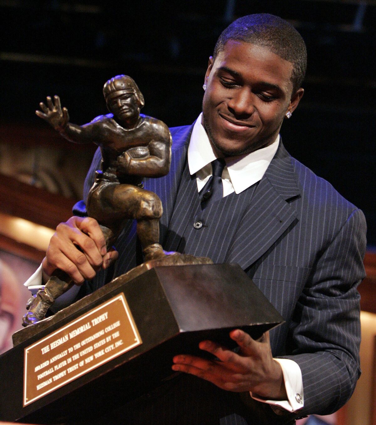 Reggie Bush picks up the Heisman Trophy after being announced as the winner in 2005. 