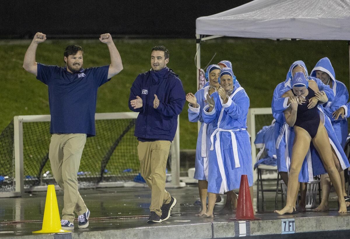 Justin Papa, left, shown after Corona del Mar beat Orange Lutheran in the CIF Southern Section Division 1 semifinals on Feb. 13, 2019, coached the Sea Kings for three seasons.