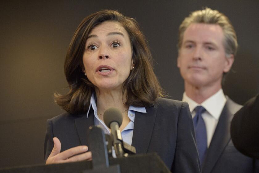 Dr. Sonia Angell is joined by California Gov. Gavin Newsom during a news conference on Feb. 27.