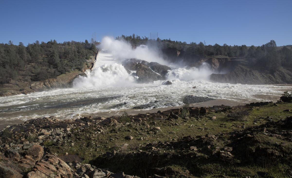 Water flows down the damaged main spillway of the Oroville Dam at 55,000 cubic feet per second into the Feather River.