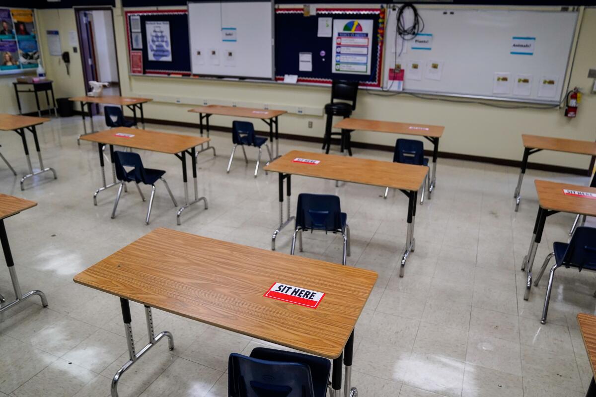  Labels on desks designate where students can sit when classrooms reopen. 