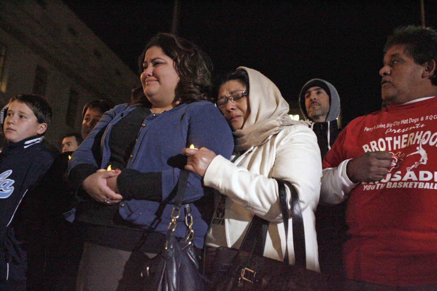 Robin Quintanilla, center, is comforted by her mother, Ana, during a vigil for Los Angeles County Sheriff's Department technician Victor McClinton, which took place at the Pasadena City Hall on Thursday, December 27, 2012.