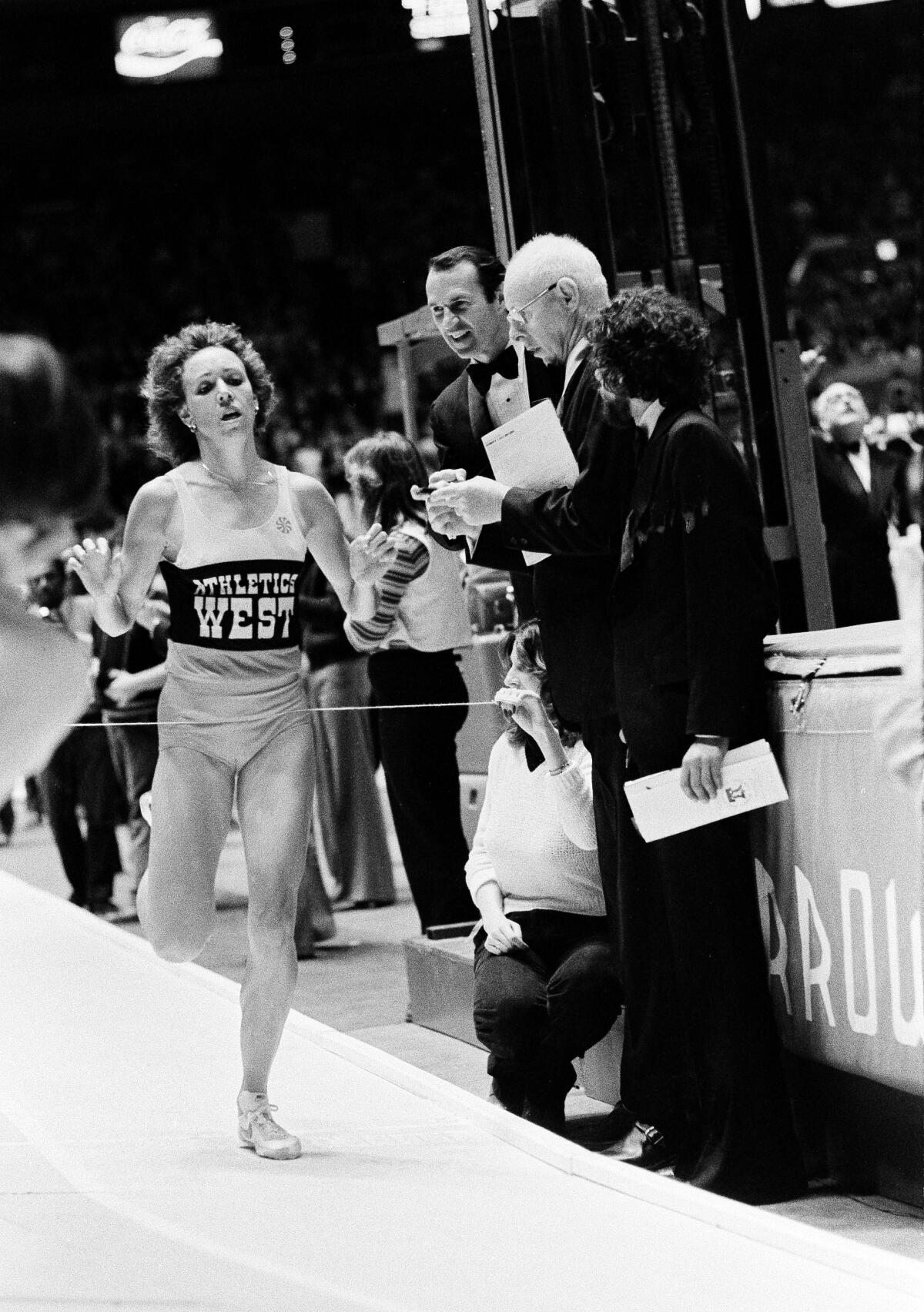 Mary Decker crosses the finish line at the Millrose Games in New York to win the women's 1,500 meters on Feb. 9, 1980.