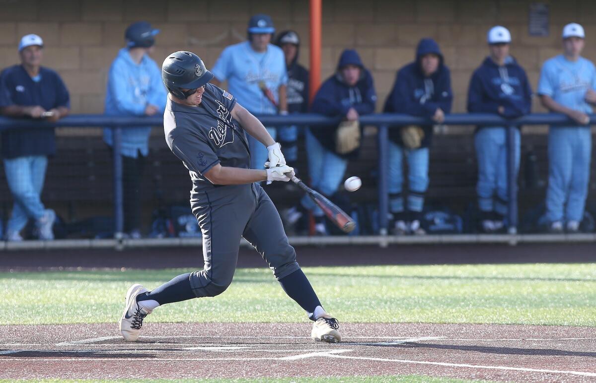 Newport Harbor High's Clay Liolios rips an RBI single during the Battle of the Bay game against Corona del Mar at Orange Coast College on Wednesday.