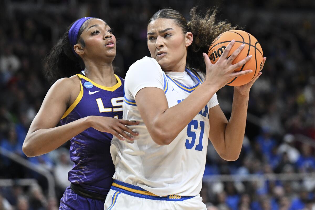 UCLA center Lauren Betts takes a pass in the post against LSU forward Angel Reese during the first quarter Saturday.