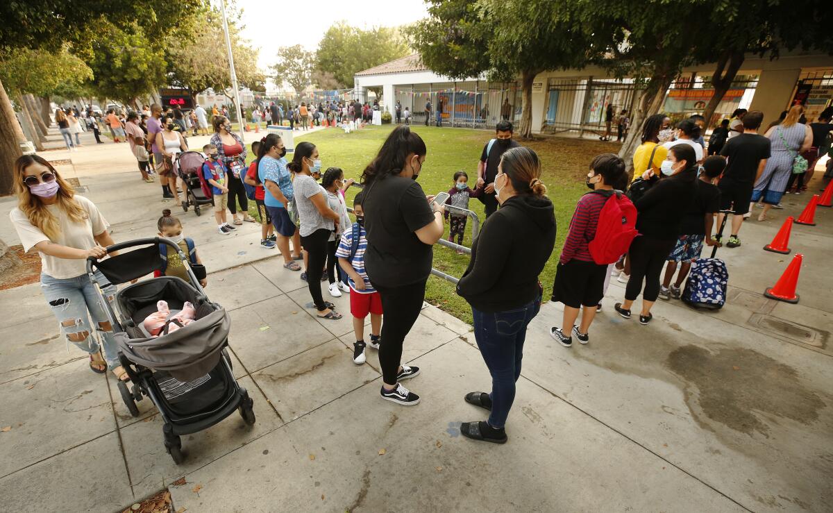 Parents and students form lines to check in at Lankershim Elementary School in North Hollywood