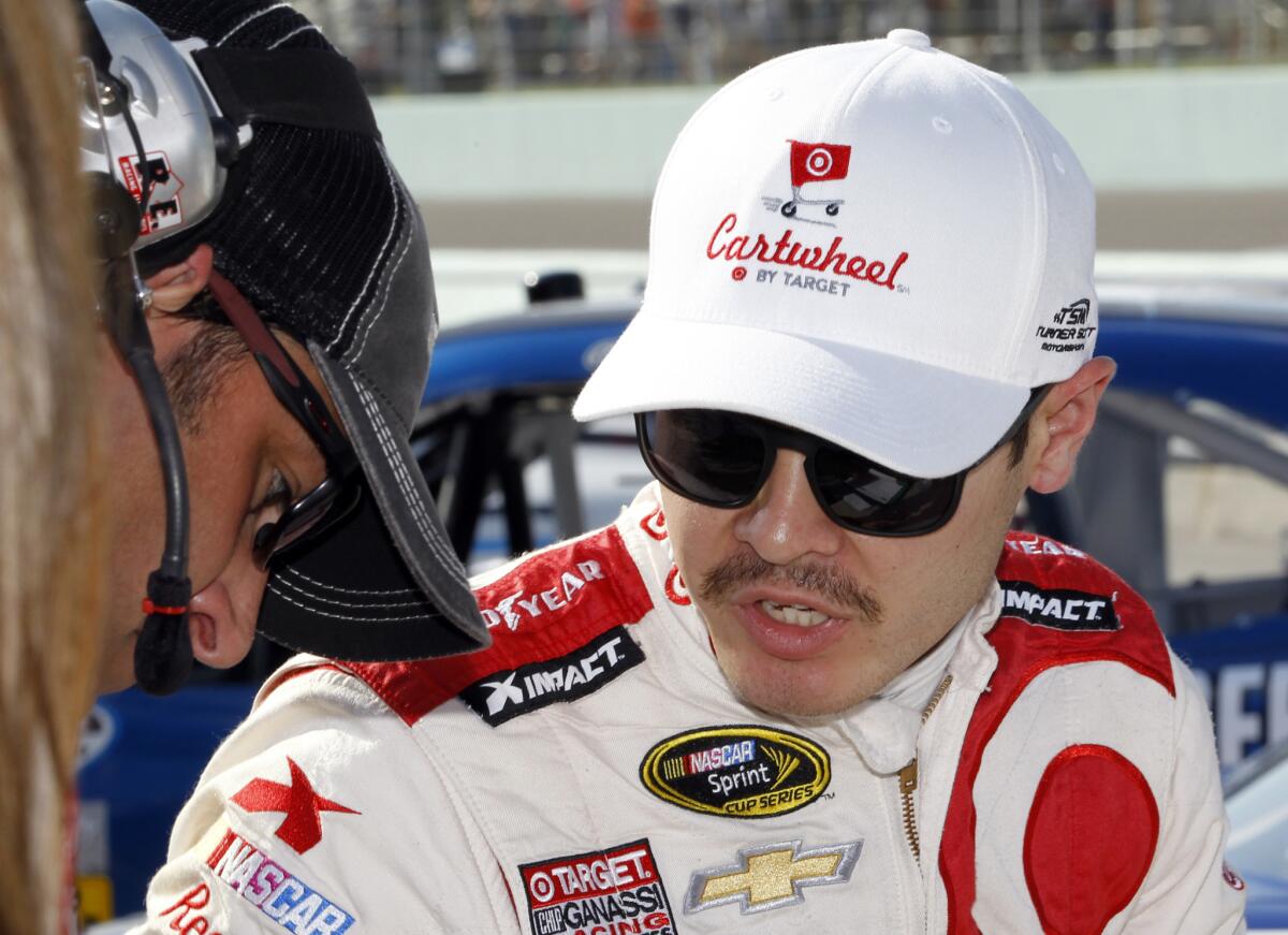Kyle Larson talks to a crew member Saturday after a Nationwide series race qualifying in Homestead, Fla.