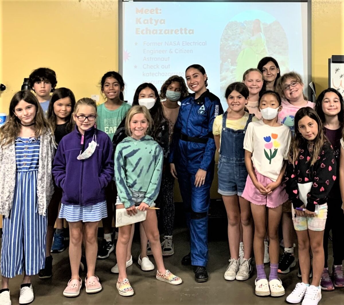 Katya Echazarreta, center, wears her Blue Origin space training uniform as she meets with students at Fleet Science Center.