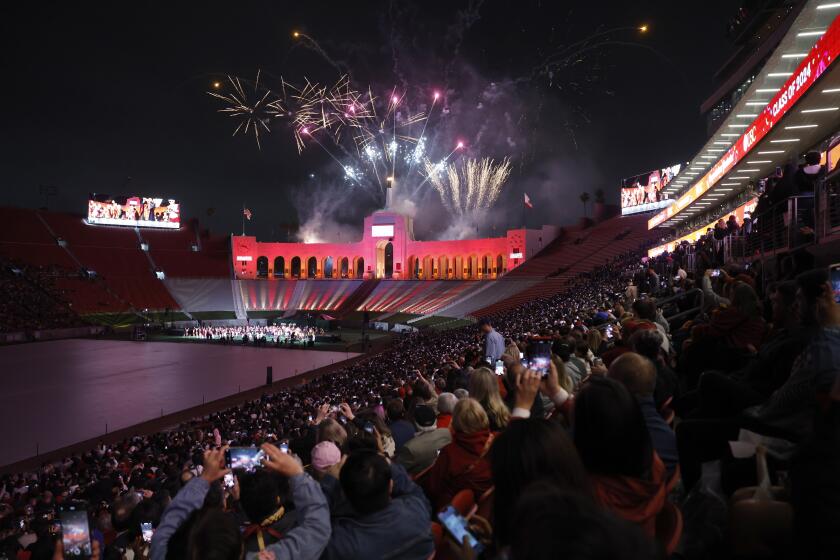 LOS ANGELES, CA - MAY 9, 2024: Fireworks go off at the "Trojan Family Graduate Celebration," at The Coliseum on May 9, 2024 in Los Angeles, California. The traditional main stage ceremony at Alumni Park was canceled due to campus unrest. (Gina Ferazzi / Los Angeles Times)