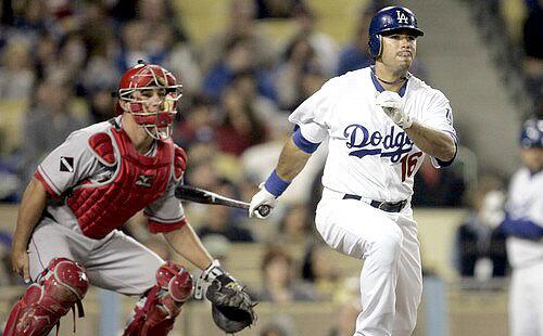 Dodgers right fielder Andre Ethier and Angels catcher Jeff Mathis watch Ethier's triple head down the right-field line during an exhibition game Thursday night at Dodger Stadium.