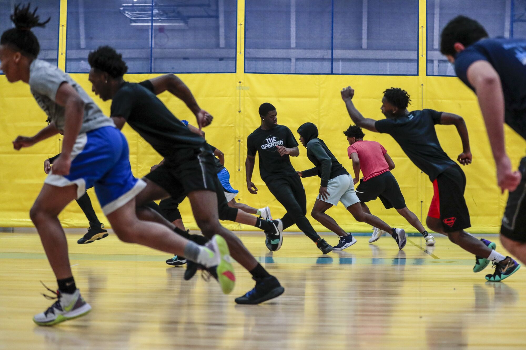 Flint basketball players run sprints in practice a day after losing Bendle.