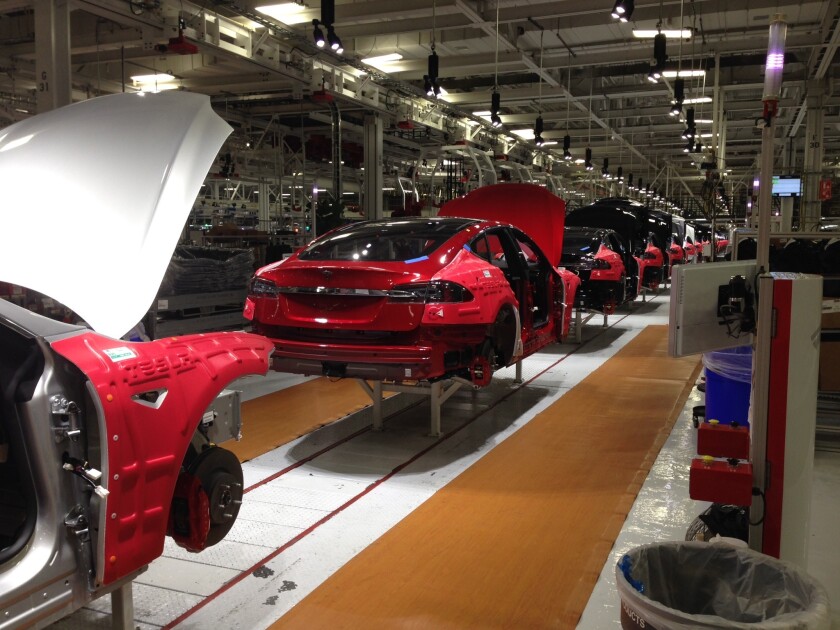 Tesla Model S sedans move down the assembly line at Tesla's electric car factory in Fremont, Calif.