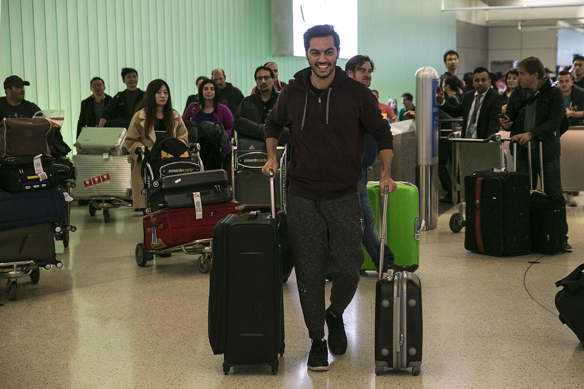 Abdullah Al-Rifaie arrives at LAX during a pause in the Trump administration travel ban.