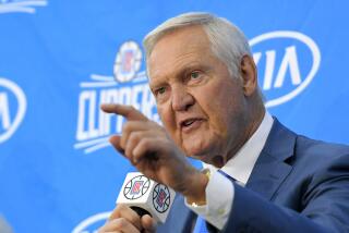  Jerry West points as he speaks during a news conference 