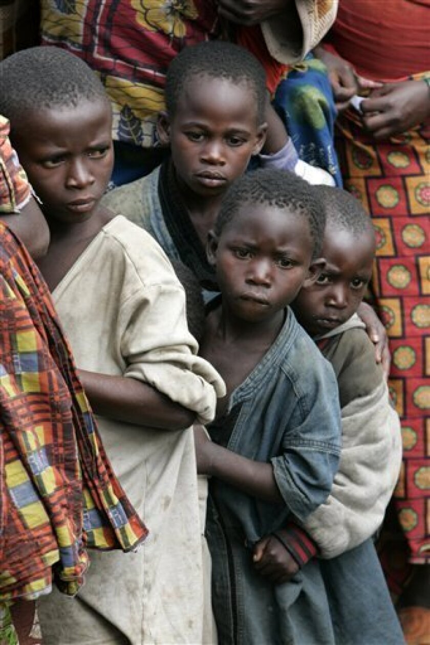 Children wait for their turn to receive high energy biscuits at a displaced people's camp, in Kibati, north of Goma, eastern Congo, Tuesday, Nov. 4, 2008. (AP Photo/Karel Prinsloo)