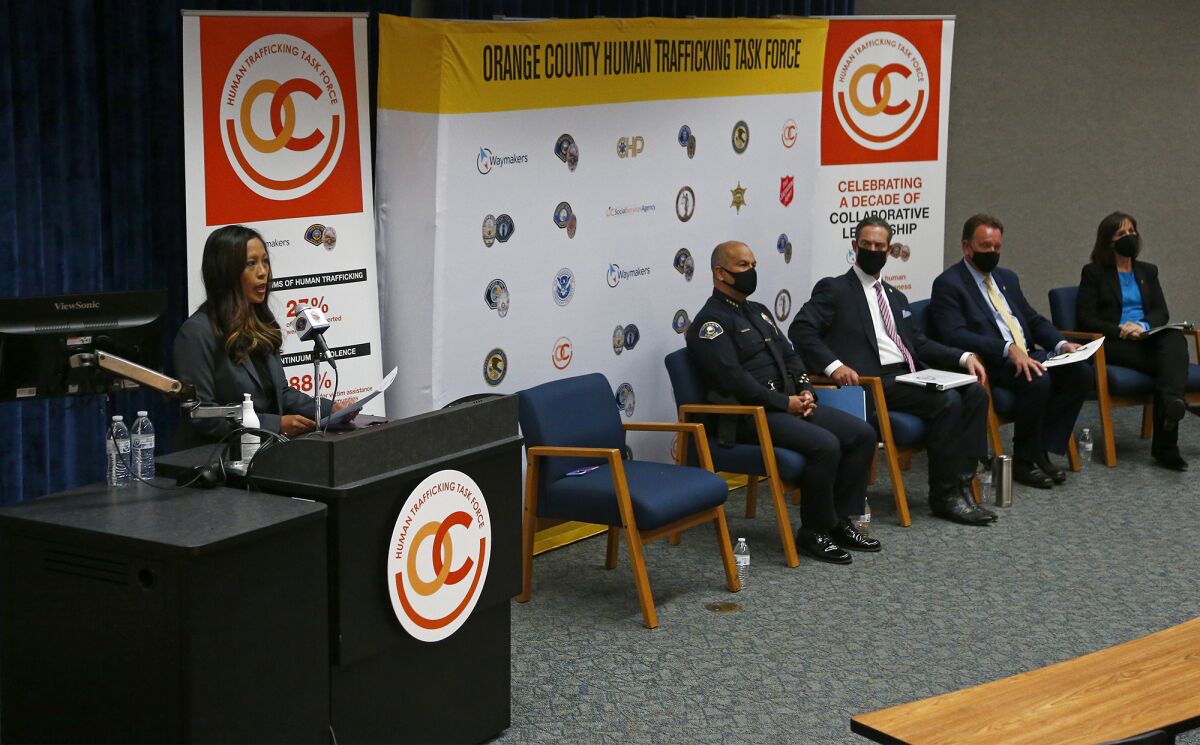 Michelle Heater, left, program director for Waymakers, speaks at a press conference.