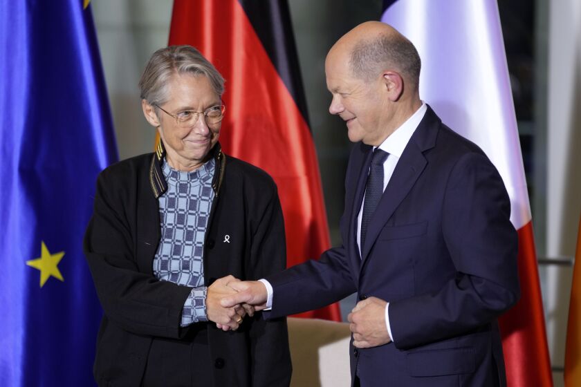 German Chancellor Olaf Scholz, right, and the Prime Minister of France, Elisabeth Borne, left, shake hands after a meeting at the Chancellery in Berlin, Germany, Friday, Nov. 25, 2022. (AP Photo/Michael Sohn)
