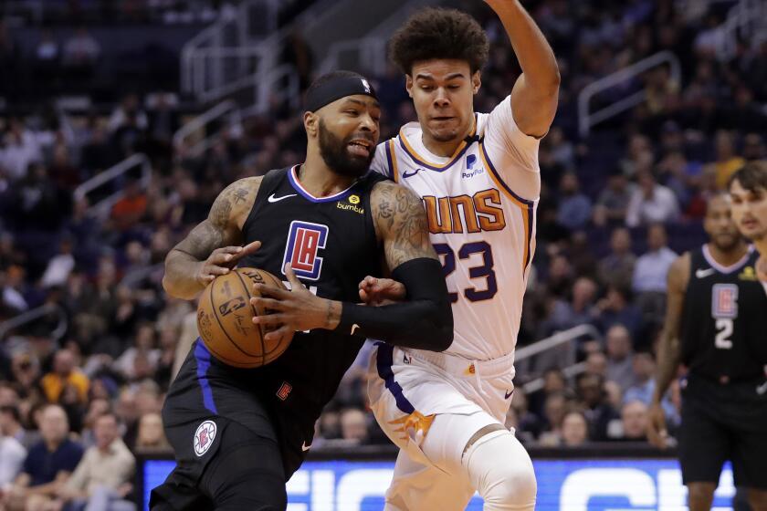 Clippers forward Marcus Morris Sr. drives against Suns forward Cameron Johnson during a game Feb. 26, 2020, in Phoenix.