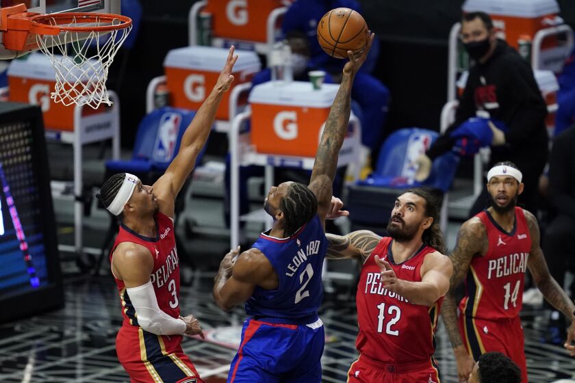 Los Angeles Clippers forward Kawhi Leonard (2) shoots between New Orleans Pelicans guard Josh Hart (3) and center Steven Adams (12) during the second quarter of an NBA basketball game Wednesday, Jan. 13, 2021, in Los Angeles. (AP Photo/Ashley Landis)
