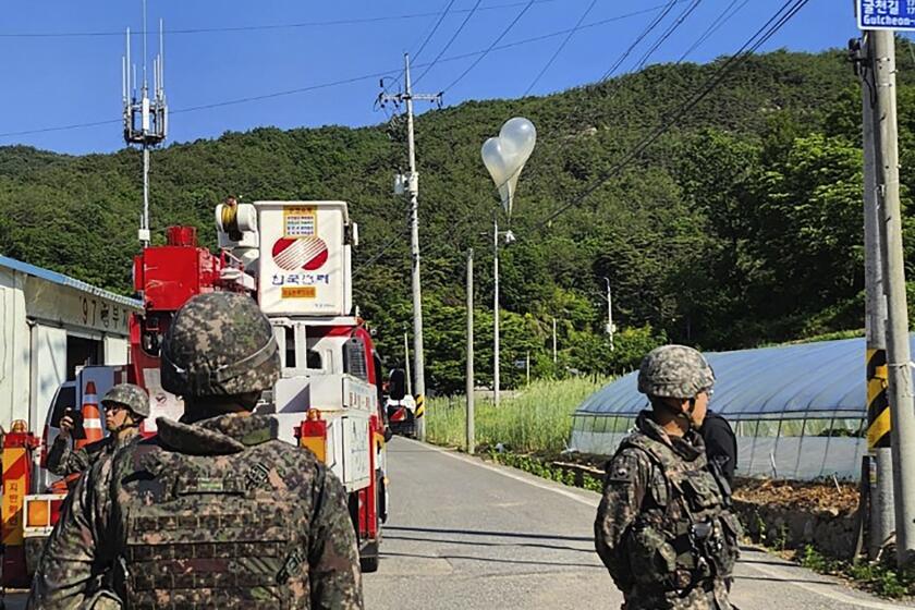 FILE - In this photo provided by Jeonbuk Fire Headquarters, balloons with trash presumably sent by North Korea, hang on electric wires as South Korean army soldiers stand guard in Muju, South Korea, on Wednesday, May 29, 2024. North Korea launched more trash-carrying balloons toward the South after a similar campaign earlier in the week, according to South Korea's military, in what Pyongyang calls retaliation for activists flying anti-North Korean leaflets across the border. (Jeonbuk Fire Headquarters via AP, File)