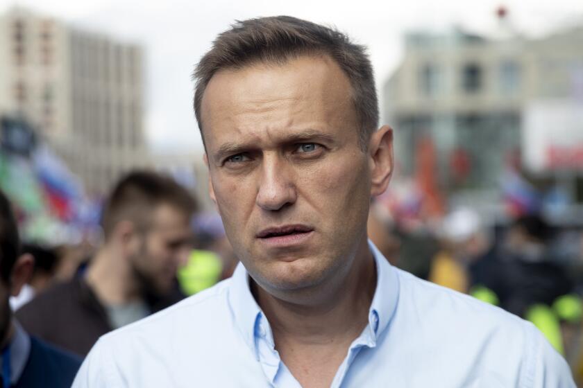 FILE - In this Saturday, July 20, 2019, file photo, Russian opposition leader Alexei Navalny attends a protest in Moscow, Russia. Navalny remained hospitalized for a second day on Monday, July 29, 2019, after his physician said he may have been poisoned. Details about Navalny's condition were scarce after Navalny was rushed to a hospital Sunday from a detention facility where he was serving a 30-day sentence for calling an unsanctioned protest. (AP Photo/Pavel Golovkin, File)