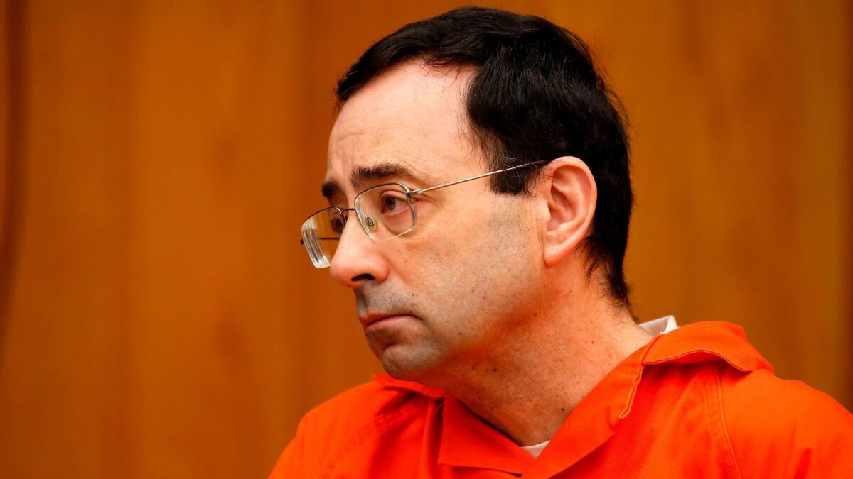 Former Michigan State and USA Gymnastics doctor Larry Nassar listens during a sentencing hearing Wednesday in Charlotte, Mich.